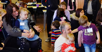 Photo of families enjoying activities in the church hall at St Paul's