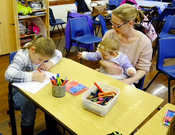 Photo of a family enjoying activities in the church hall at St Paul's